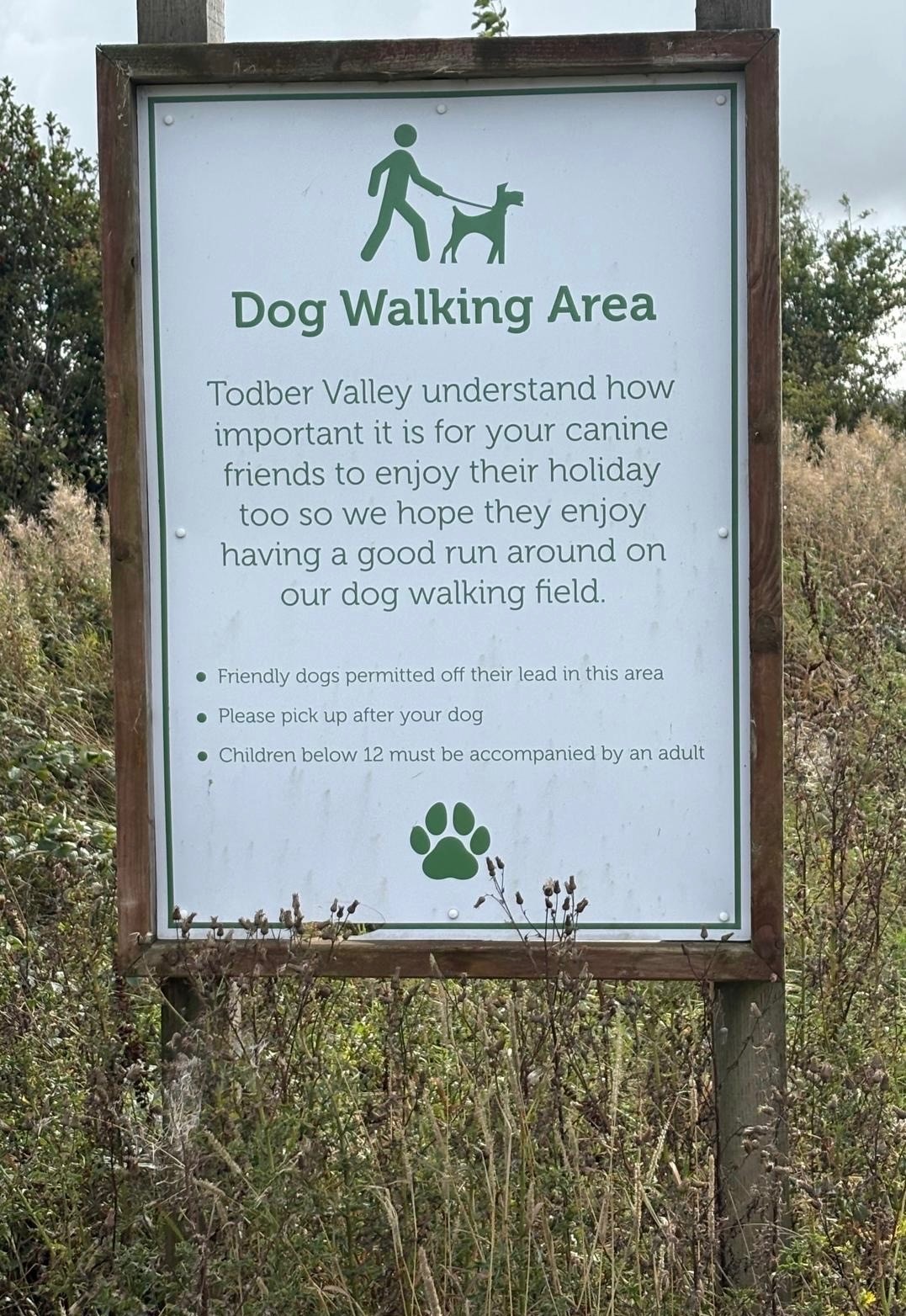 The dog walking area sign on the park's dog field