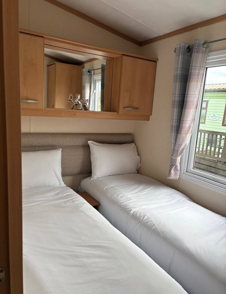 Second bedroom with two single beds and countryside outlook