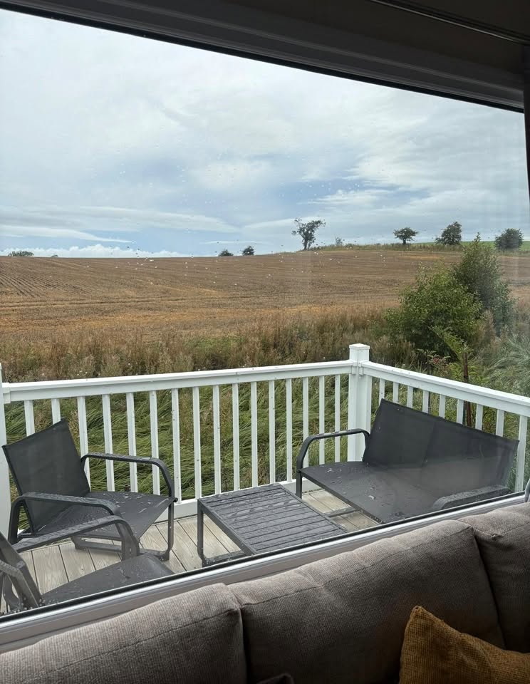 View from the living area out over the decking and open fields